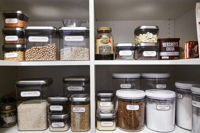 Clear, labeled jars of foods including rice and lentils.