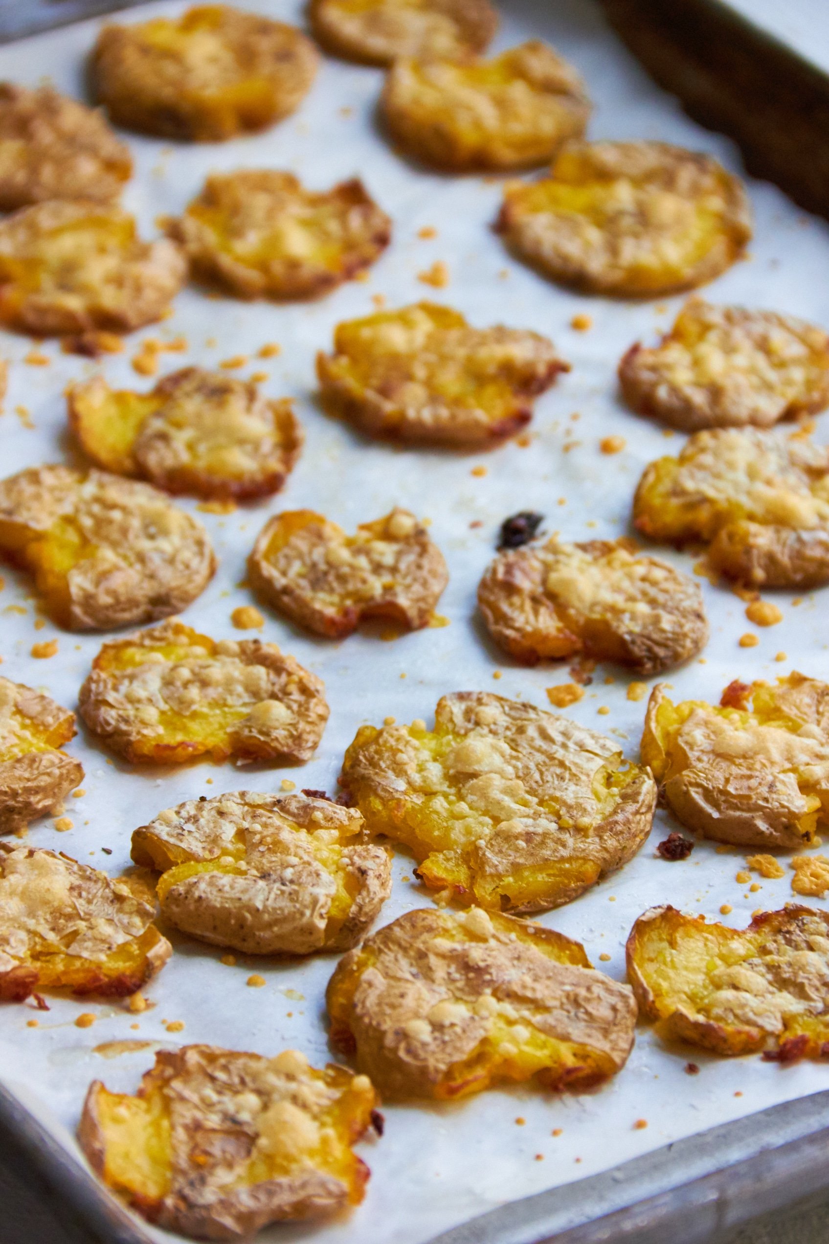 Smashed Roasted Baby Potatoes on parchment paper.