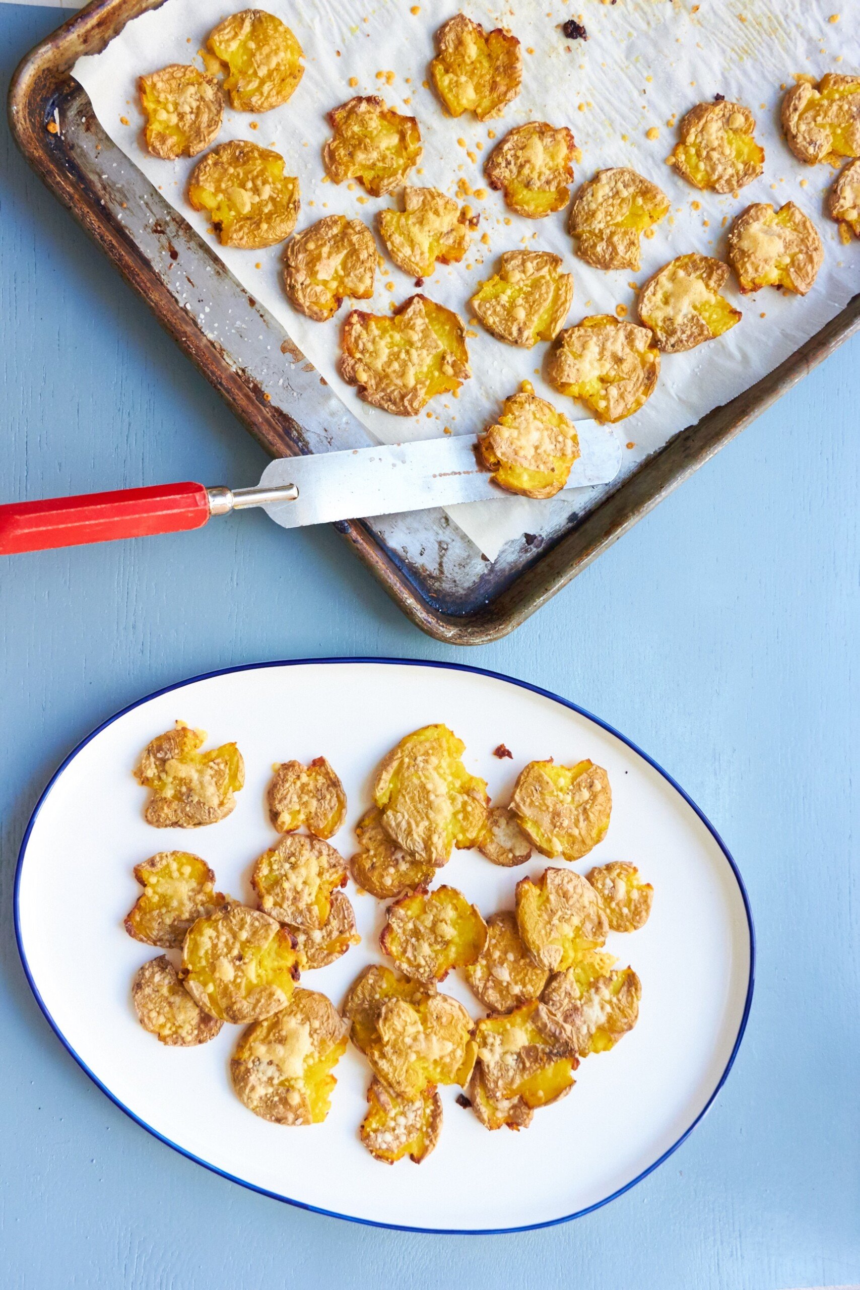 Smashed Roasted Baby Potatoes on a baking sheet and a plate.