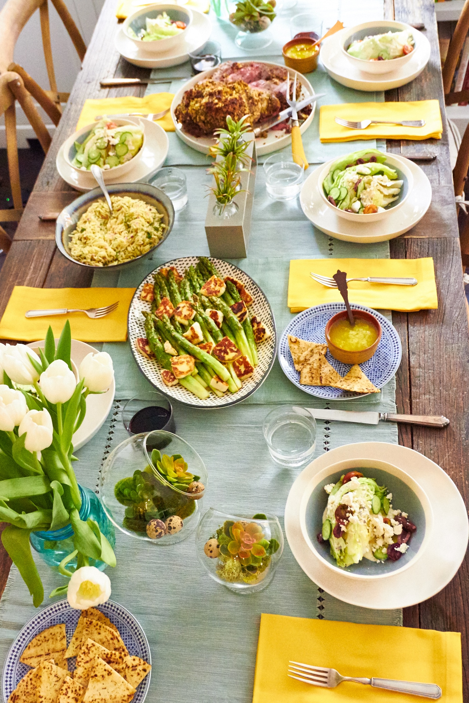 Easter dinner table featuring Greek dishes.