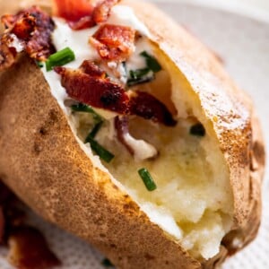Baked Potato topped with chives, sour cream, and bacon.
