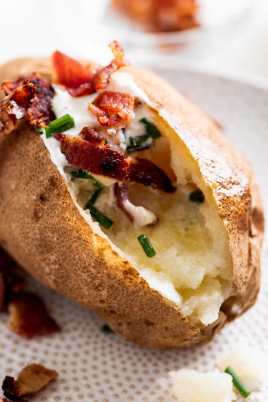 Baked Potato topped with chives, sour cream, and bacon.