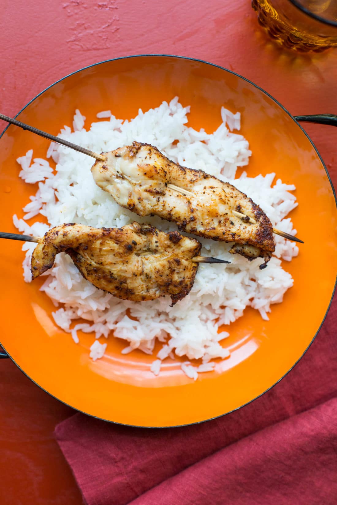 Rice topped with Chicken Tender Skewers with Spiced Curry Rub.