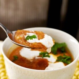 Spoon with a scoop of Moroccan Carrot and Cauliflower Soup.