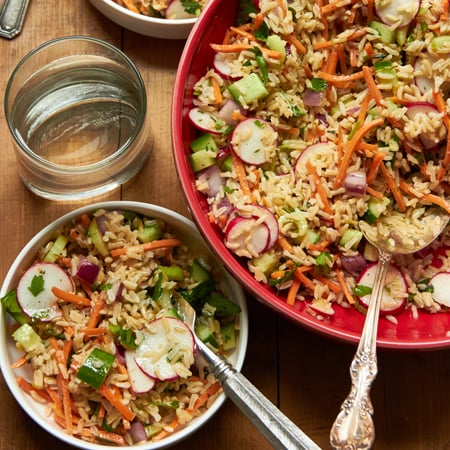 Vegetable and Brown Rice Salad in bowls on table.