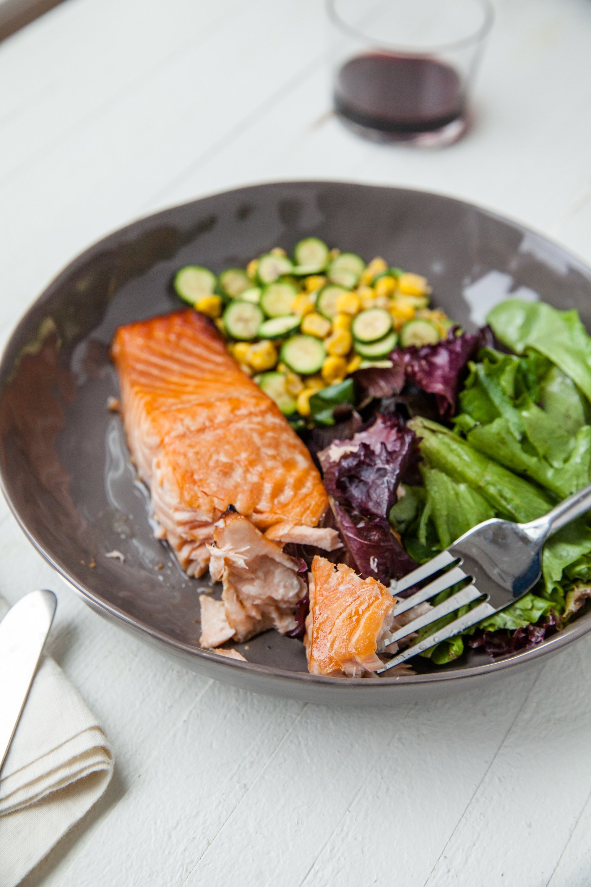 Simple Asian Salmon with Sautéed Corn and Zucchini on brown plate.