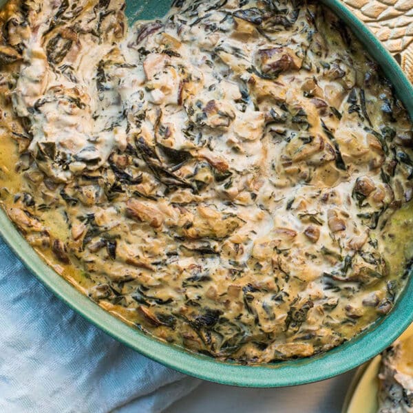 Hot Spinach and Goat Cheese Dip and crackers on table.