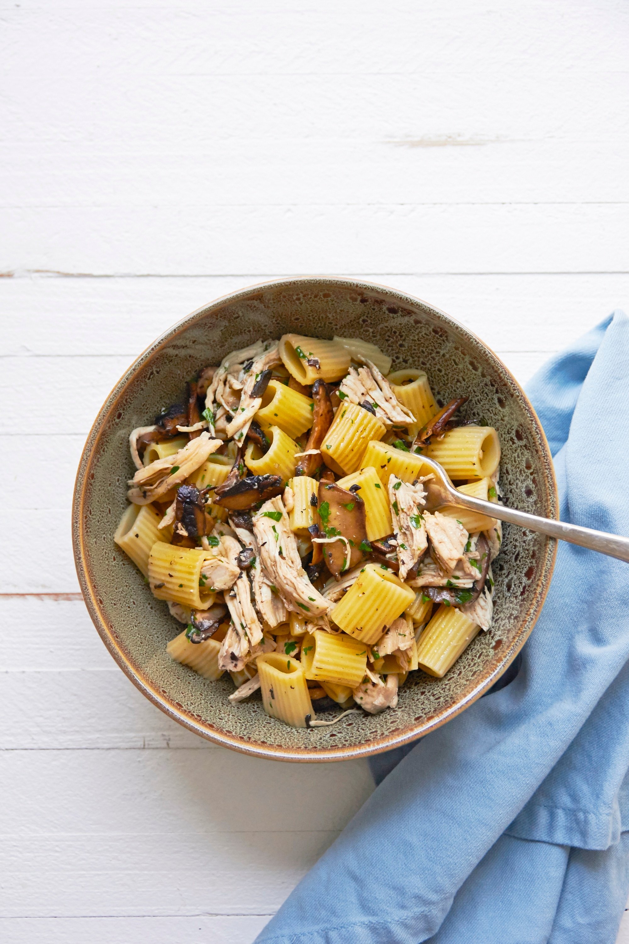 Pasta with chicken and mushrooms in a bowl.