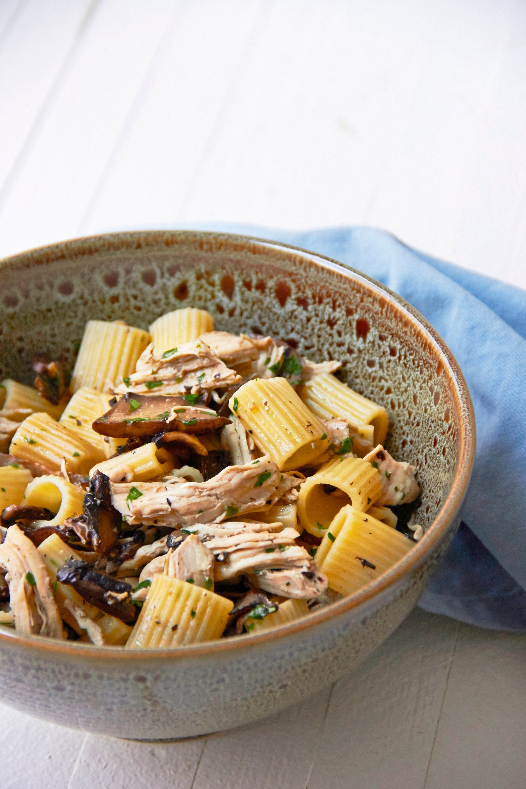 5-Ingredient Pasta: Chicken and Mushroom Marsala Rotelle in a bowl with blue napkin.