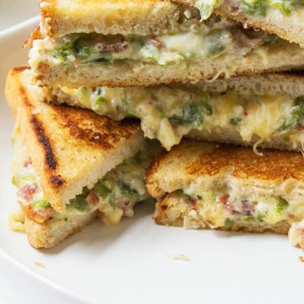 Jalapeno Popper Grilled Cheese stacked on plate.