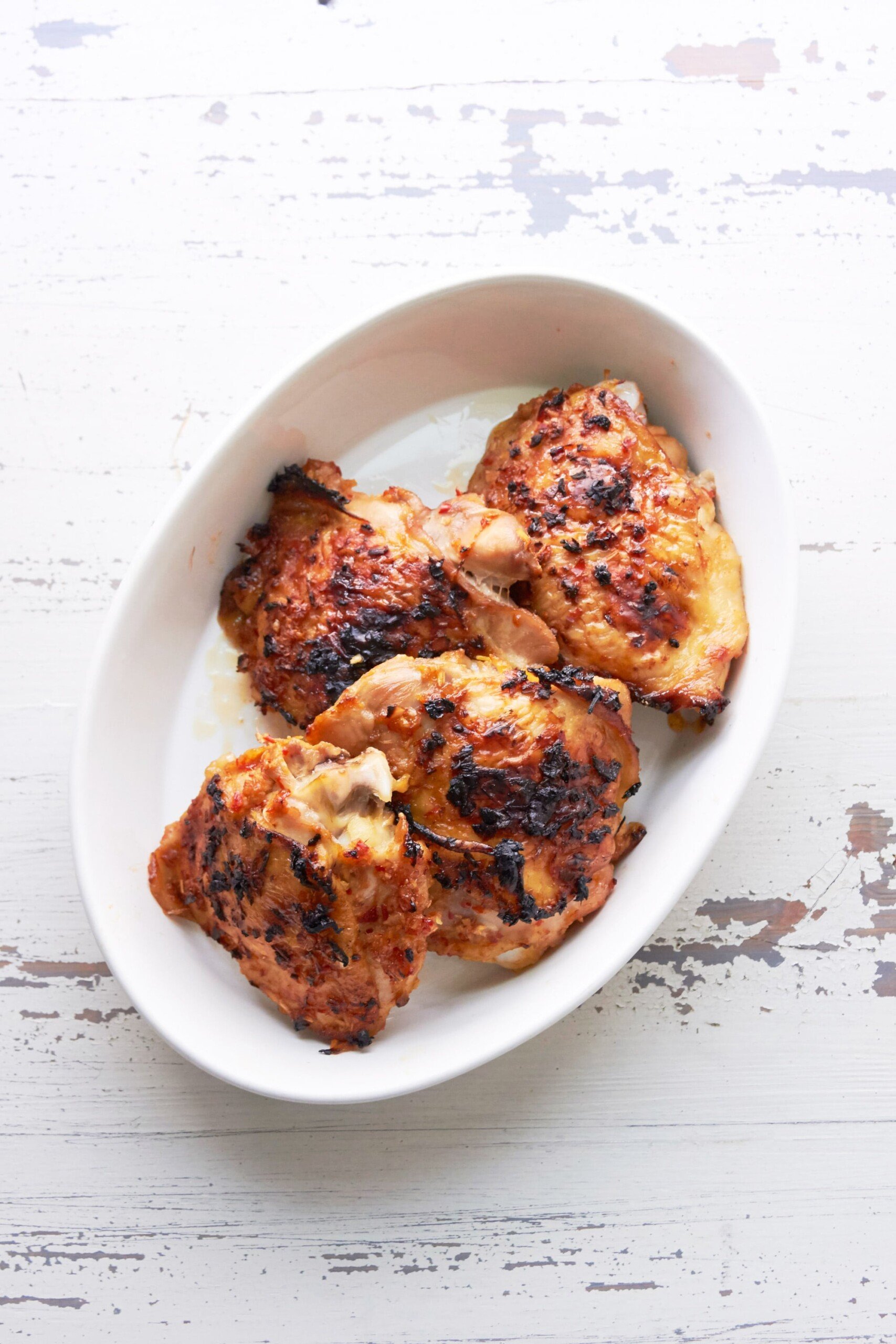 Thai Chicken Thighs on white serving platter.