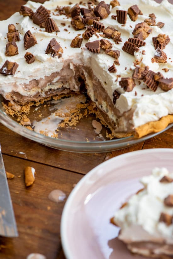 Glass pie plate with a Chocolate Peanut Butter Ice Cream Pie missing a slice.