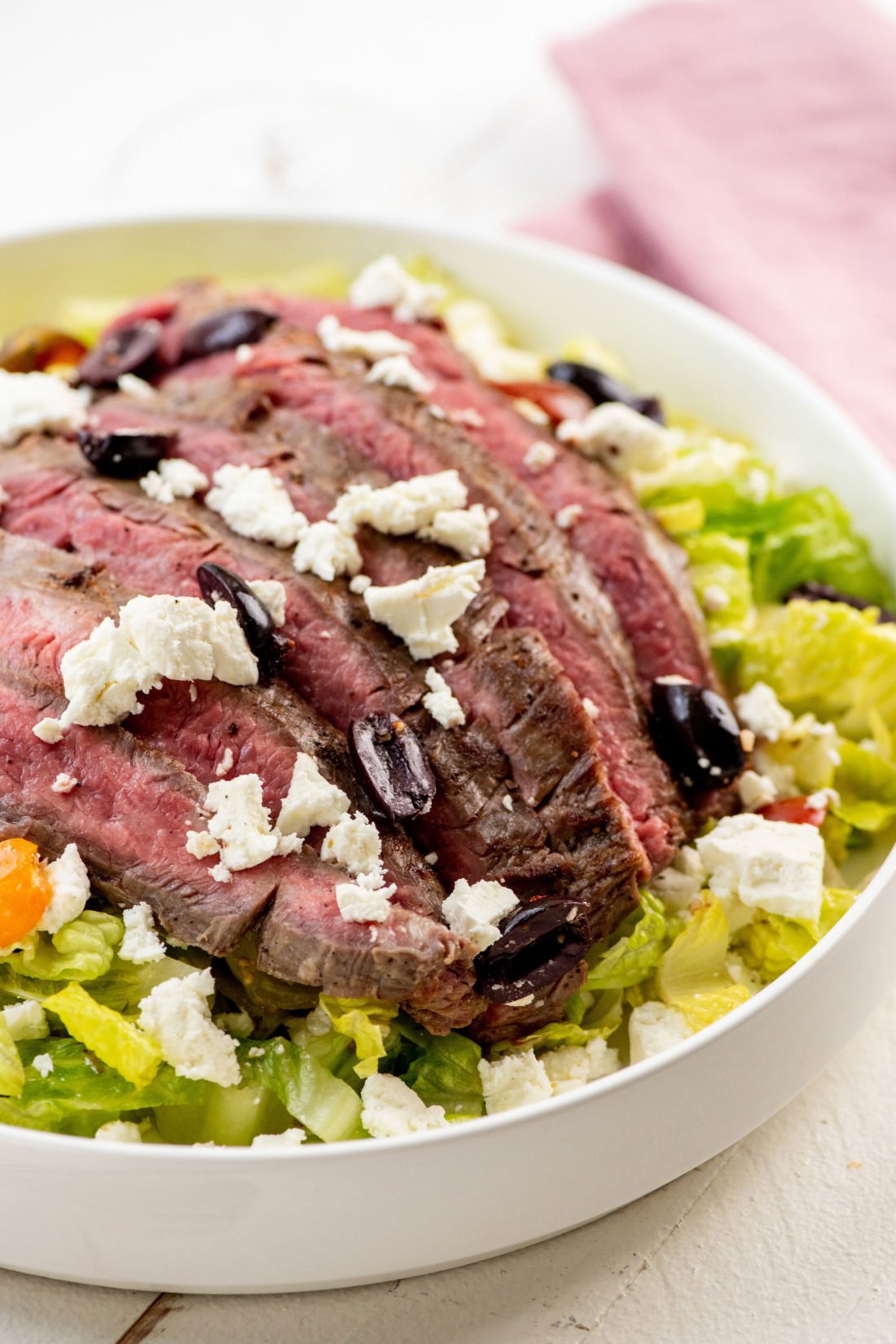 Greek Salad with Flank Steak in a large bowl.