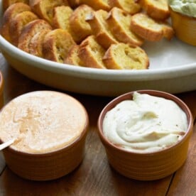 Bowls of Whipped Fresh Ricotta dips with slices of bread.