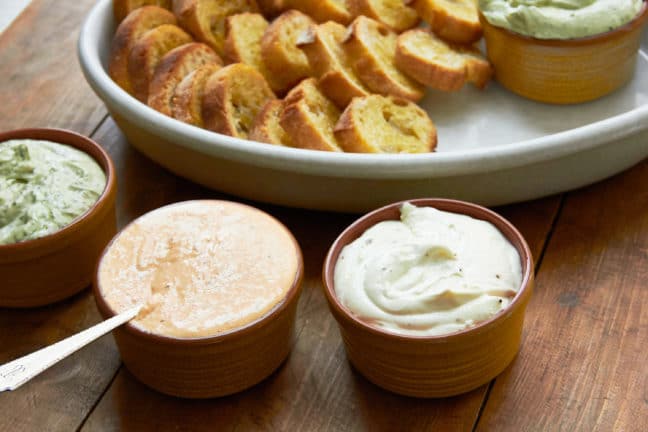 Bowls of Whipped Fresh Ricotta dips with slices of bread.