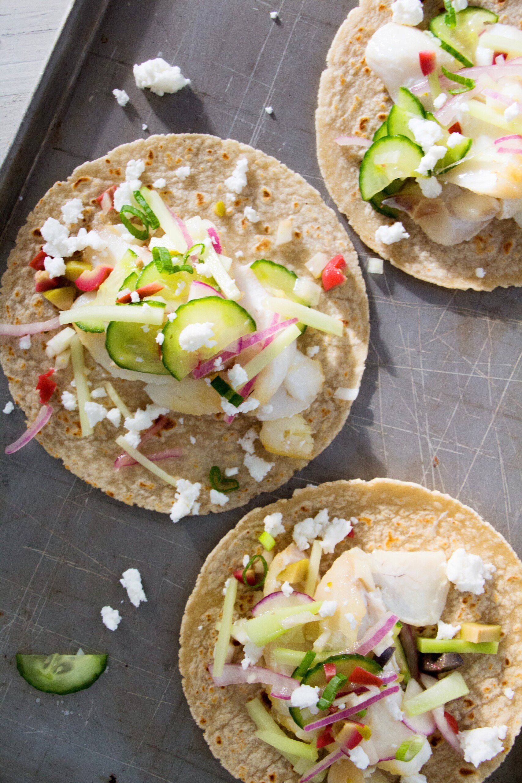 Flaky Fish Tacos with Vegetable Slaw on a baking sheet.