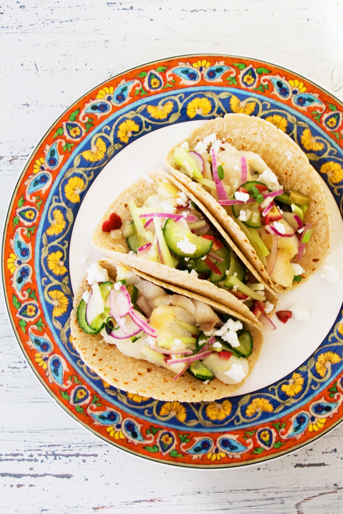 Colorful plate with three Flaky Fish Tacos with Vegetable Slaw.