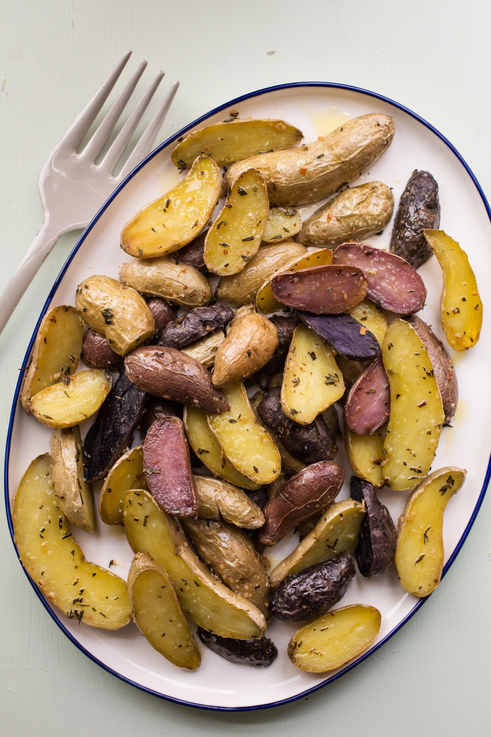 Herb Roasted Fingerling Potatoes on white platter.
