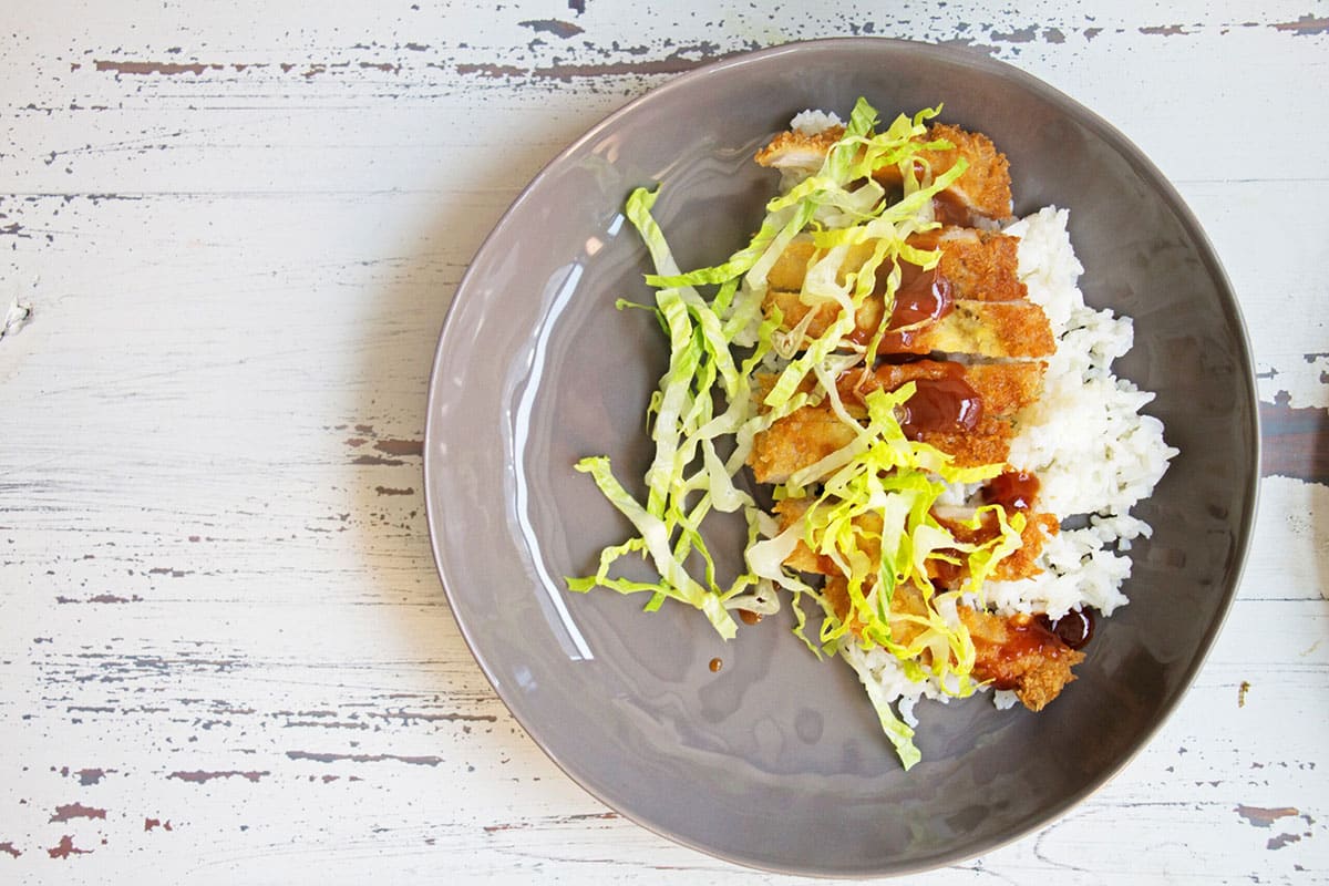 Tonkatsu-Style Cutlets on plate with rice.