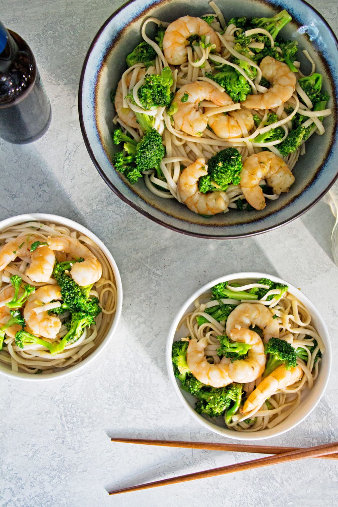 Three bowls of Shrimp and Broccoli Stir Fry with Udon Noodles.