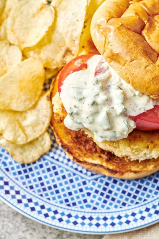 Blue and white plate of chips and a Fried Fish Sandwich.