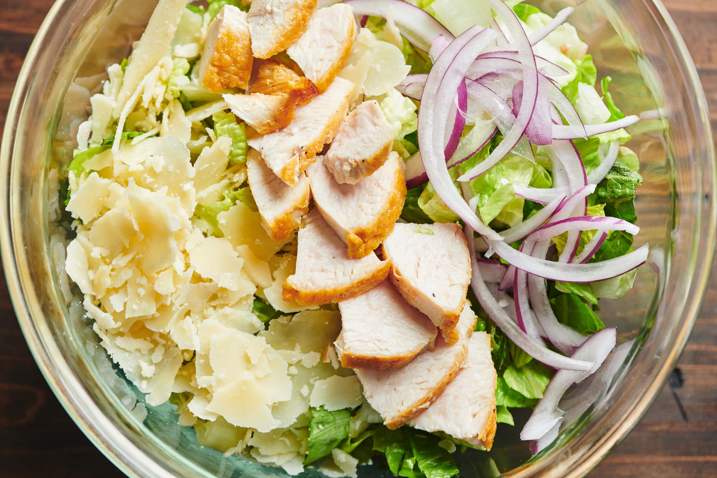 Ingredients for Chicken Caesar Salad in a bowl.