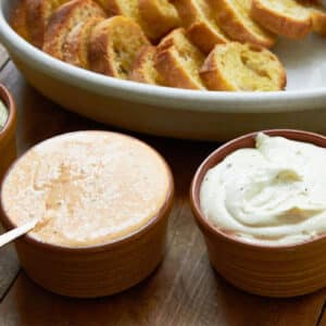 Bowls of Whipped Fresh Ricotta dips with slices of bread.