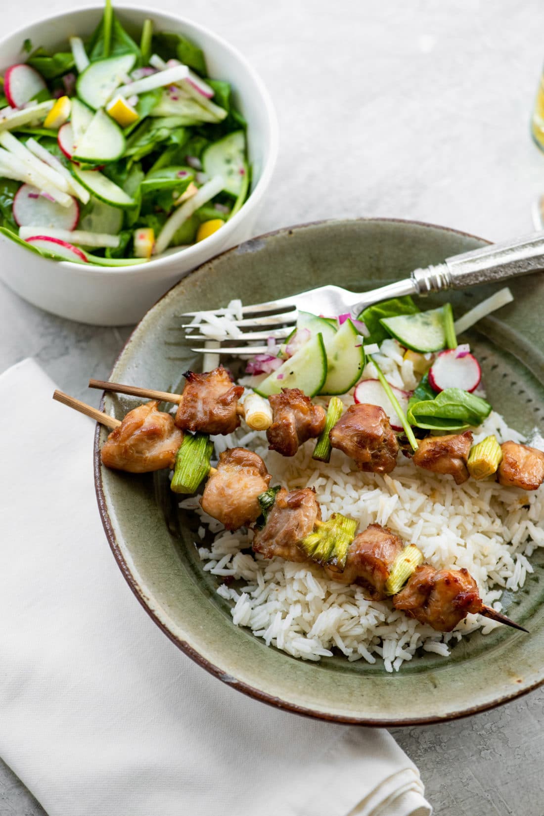 Plate of Chicken Yakitori, rice, and salad.