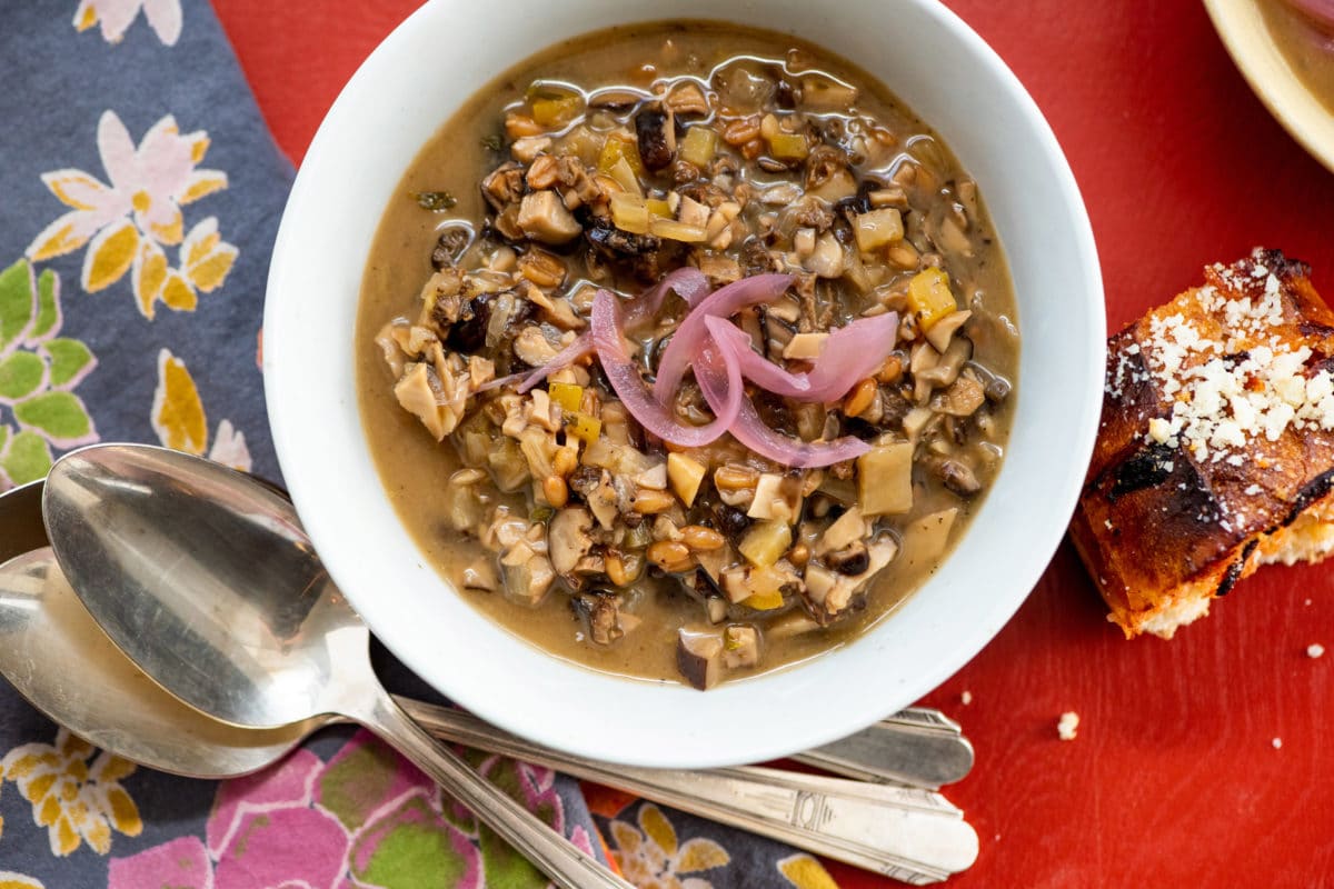 Pickled onions in a bowl of Mushroom Spelt Soup.