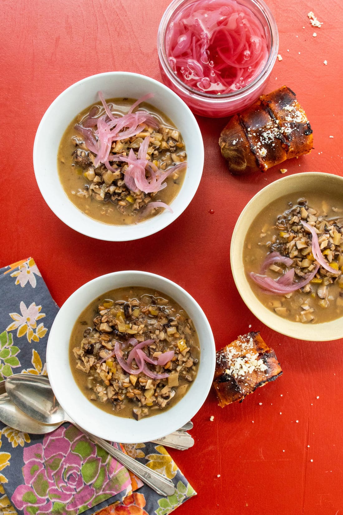 Bowls of Mushroom Spelt Soup on a table with bread.