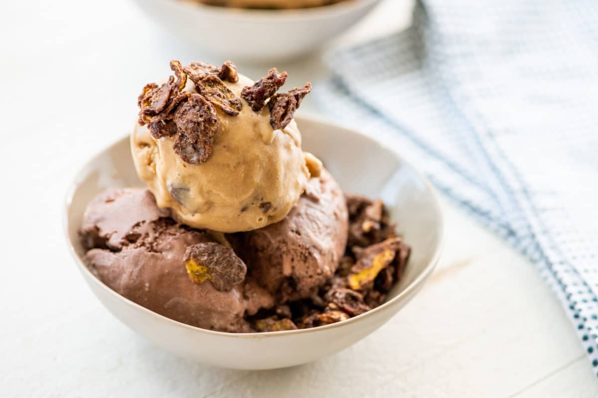 Chocolate Peanut Cornflake Crunch on chocolate ice cream in bowl.