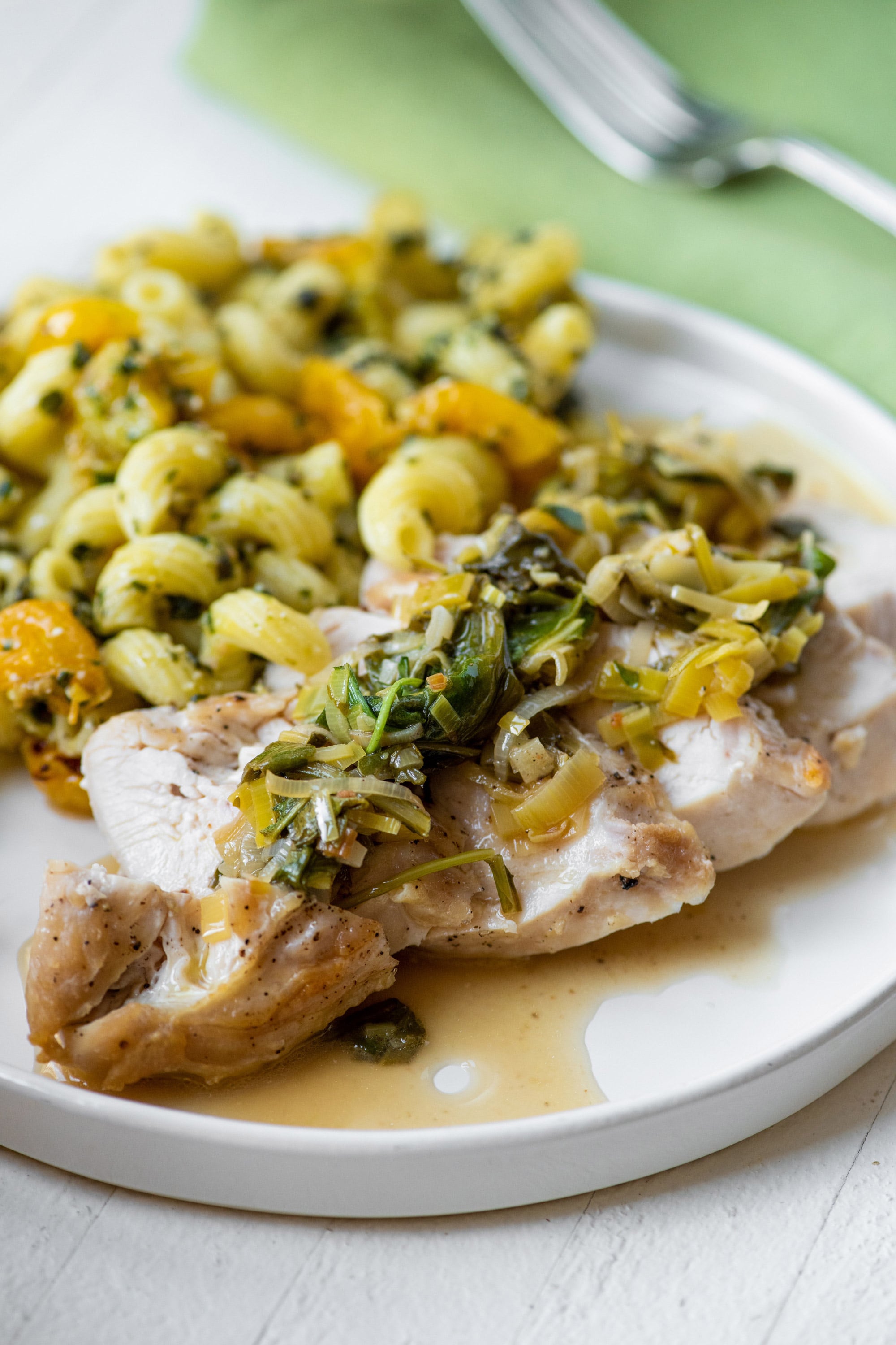 Chicken with White Wine, Leek, Spinach and Arugula Pan Sauce on a plate.