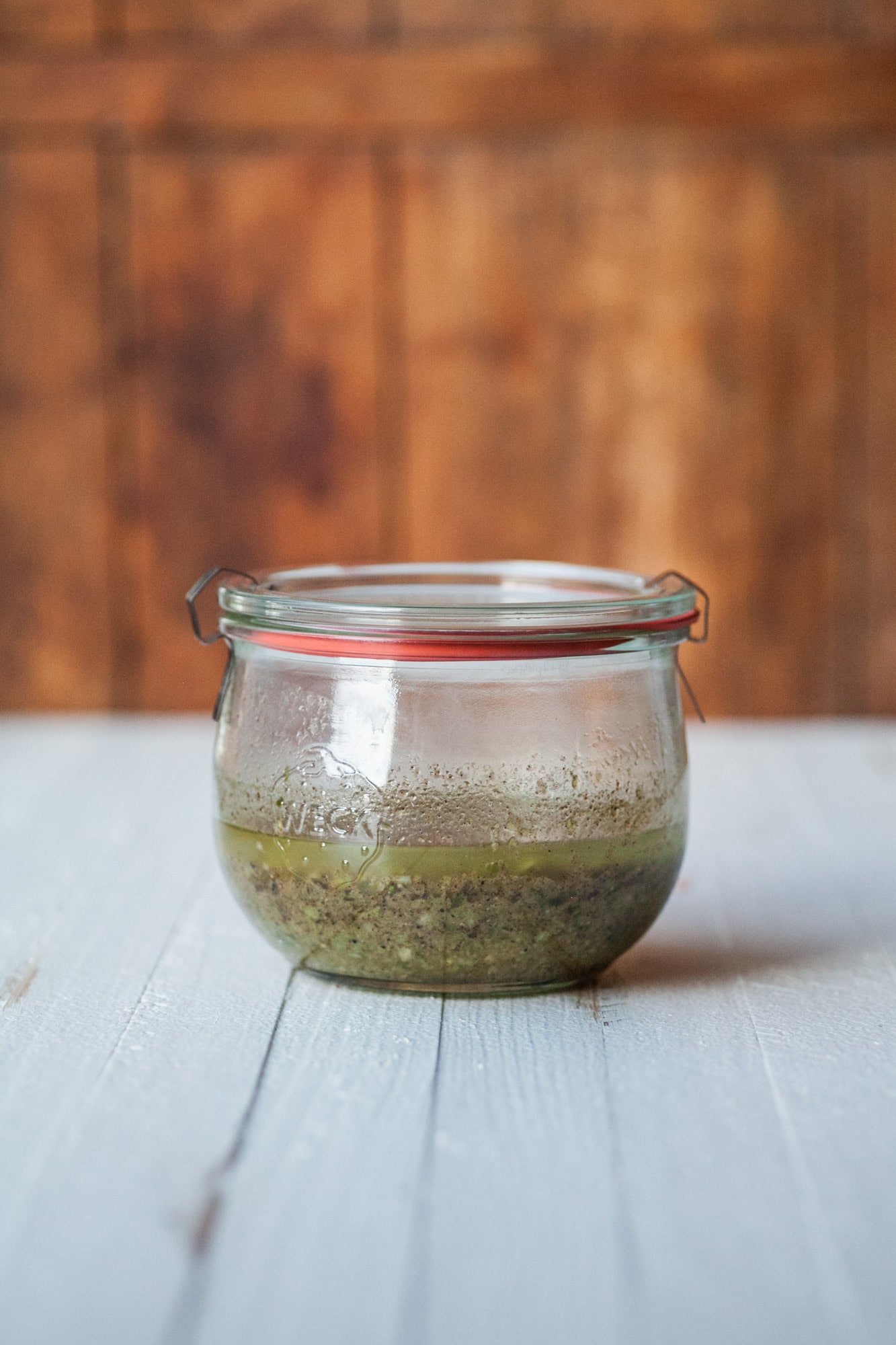 Glass jar filled with green Jamaican Jerk Marinade.