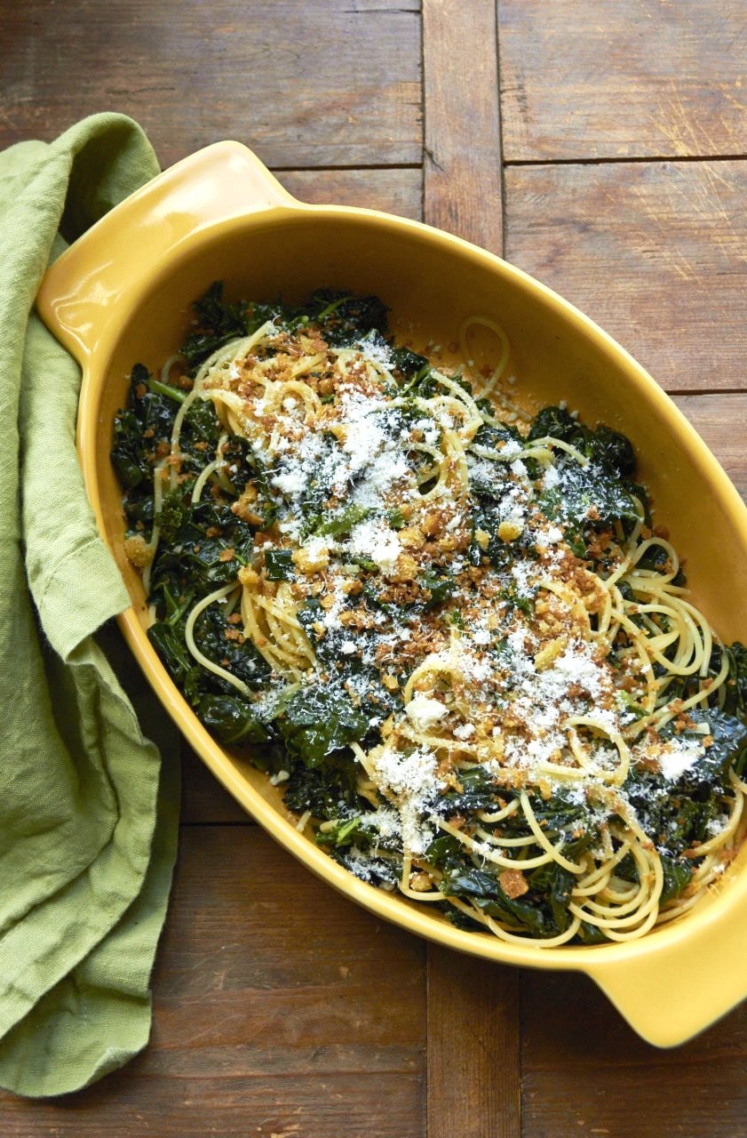 Pasta with Sautéed Kale and Toasted Bread Crumbs in yellow serving dish.