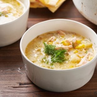 Bowl of Salmon Corn Chowder topped with fresh dill.