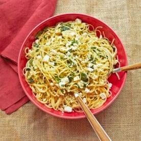 Red serving bowl with Linguine with Lemon, Feta and Basil.