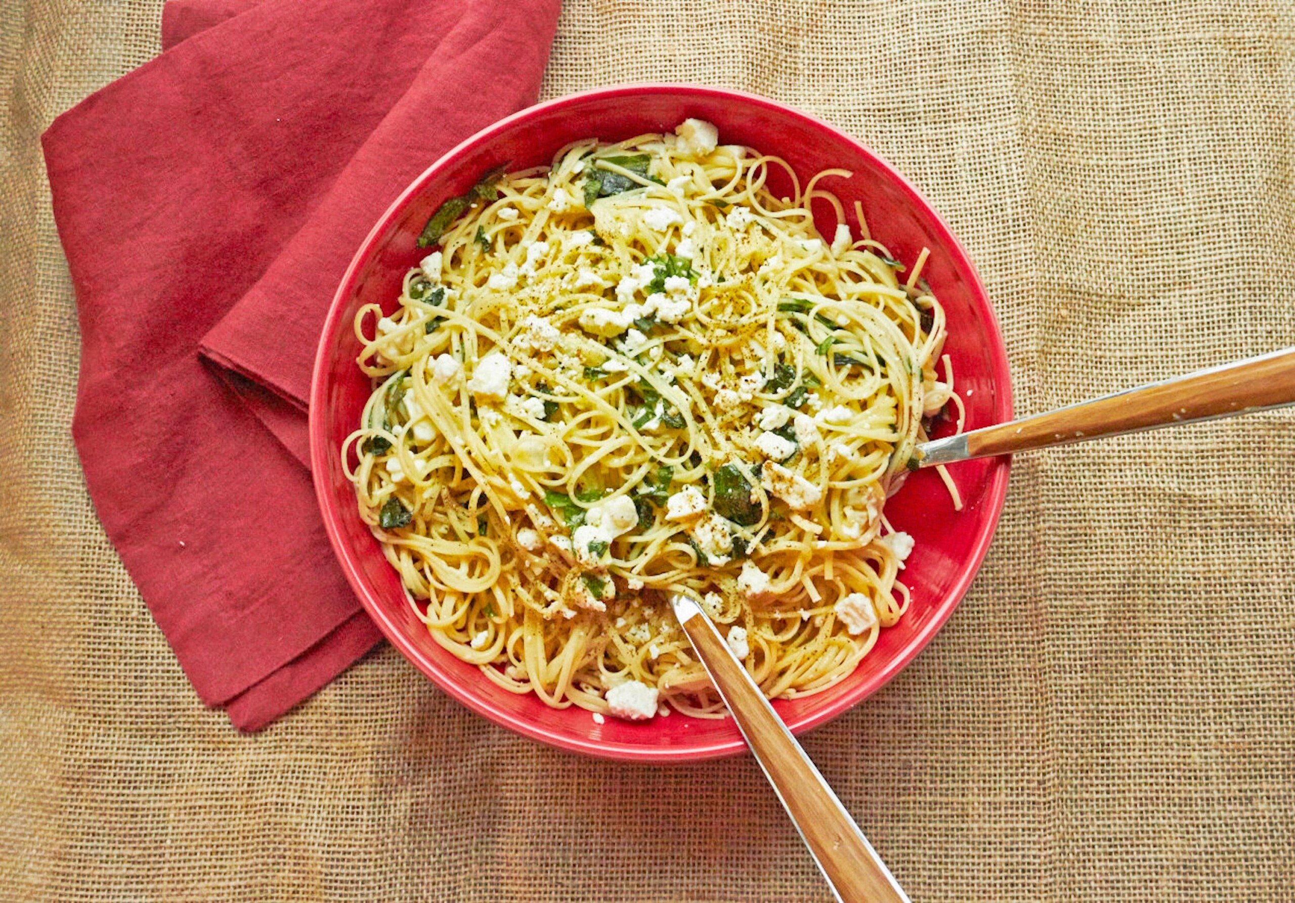 Red serving bowl with Linguine with Lemon, Feta and Basil.