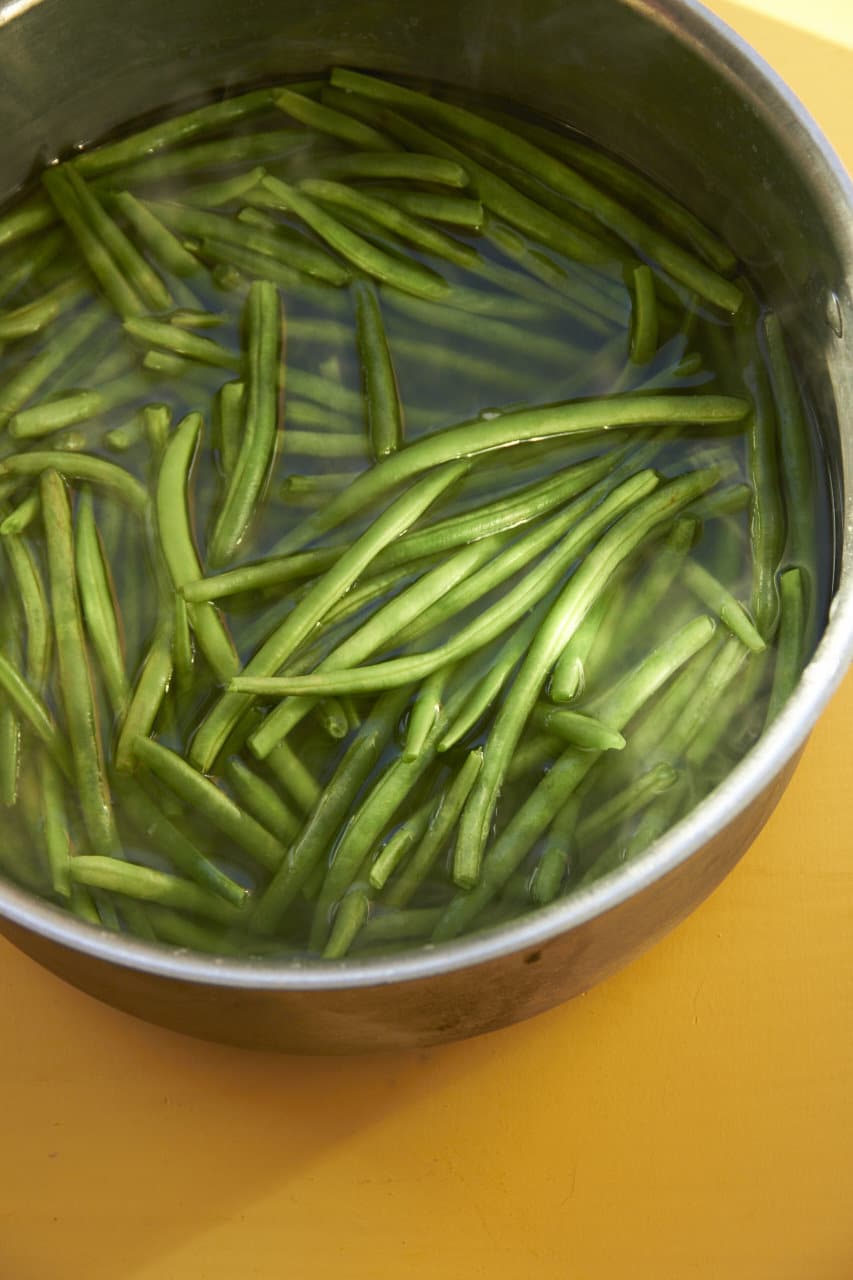 Blanching green beans in large pot of water.