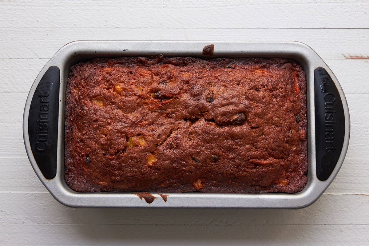Loaf of Carrot Raisin Bread in pan.