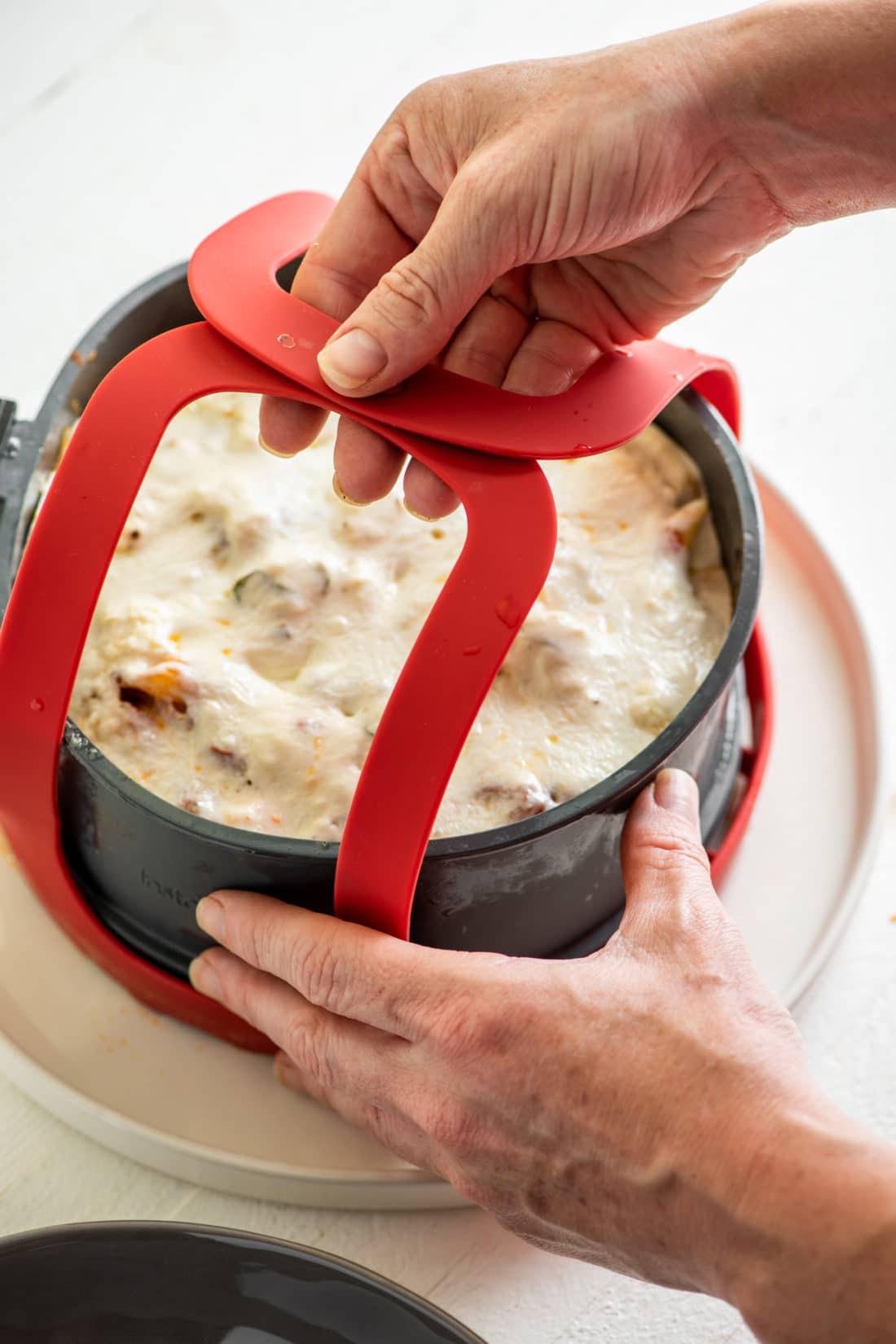 Red sling lifting a pan.