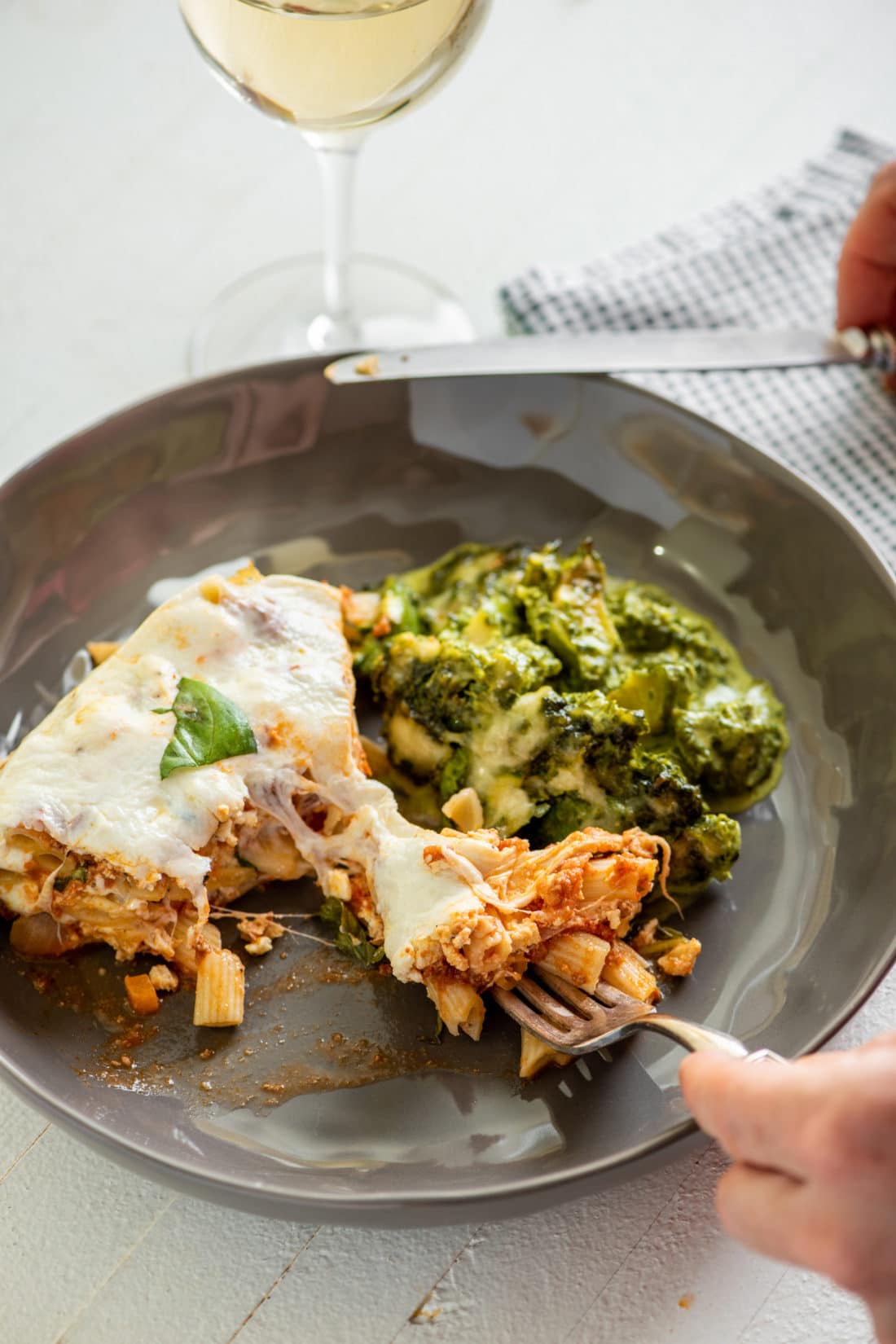 Ziti “Lasagna” with Bolognese Sauce on a plate with vegetables.