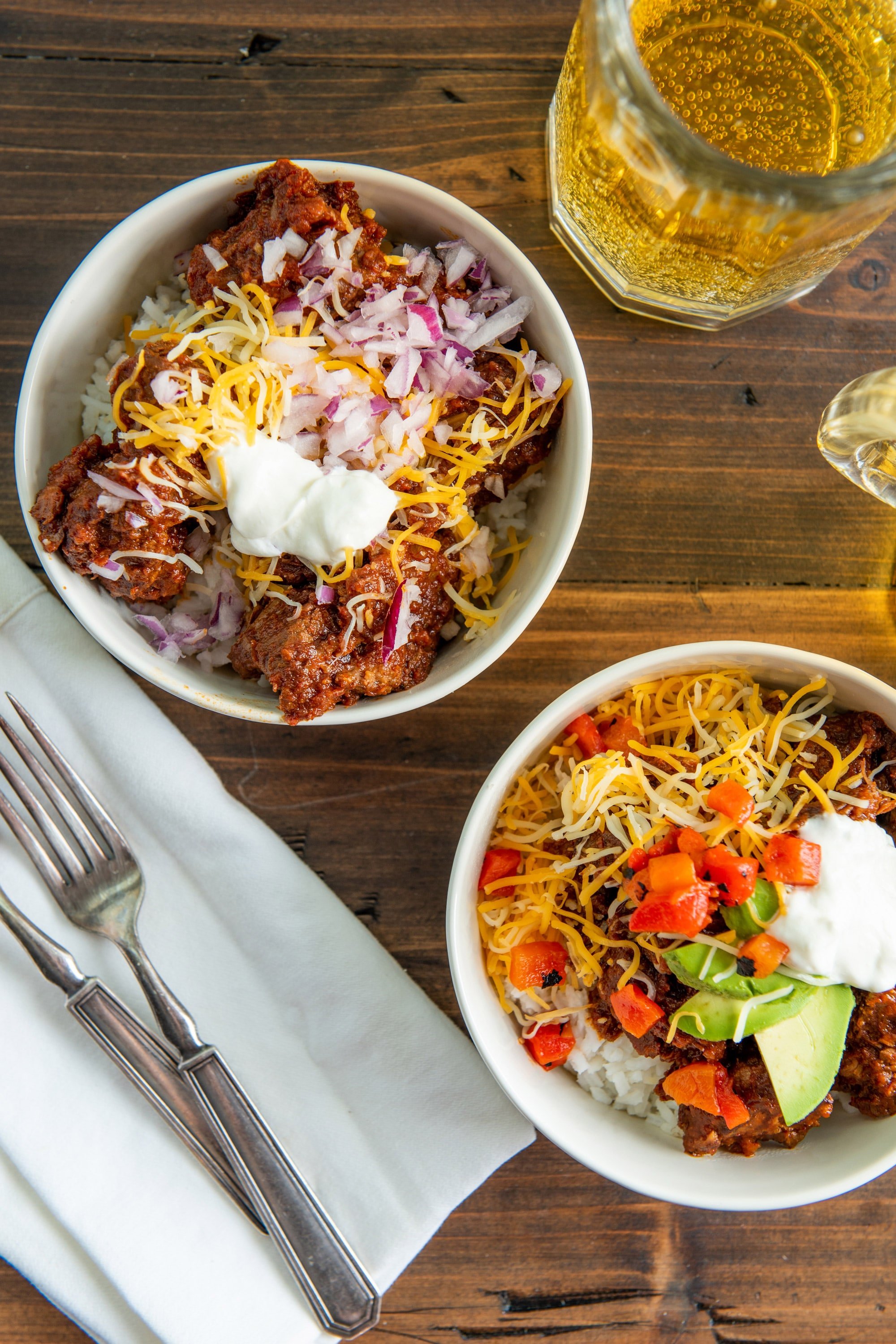 Homemade Texas Chili Recipe in bowls with various toppings.