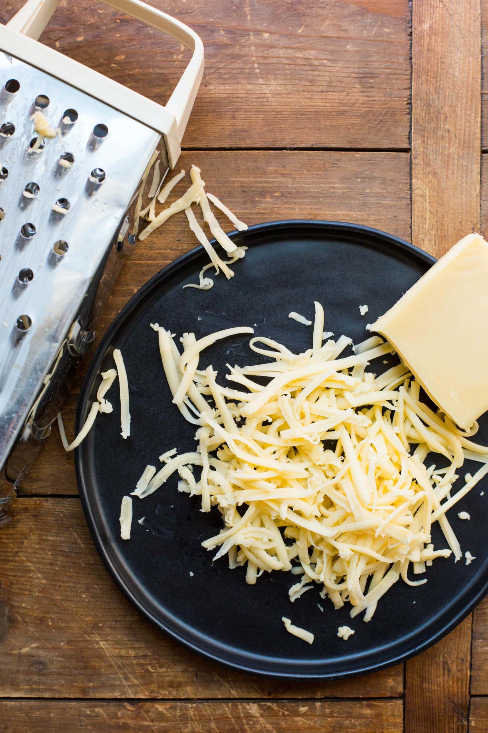 Grating Cheese / Katie Workman / themom100.com / Photo by Mia