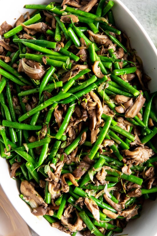 Green Beans and Mushrooms with Shallots piled high in a dish.