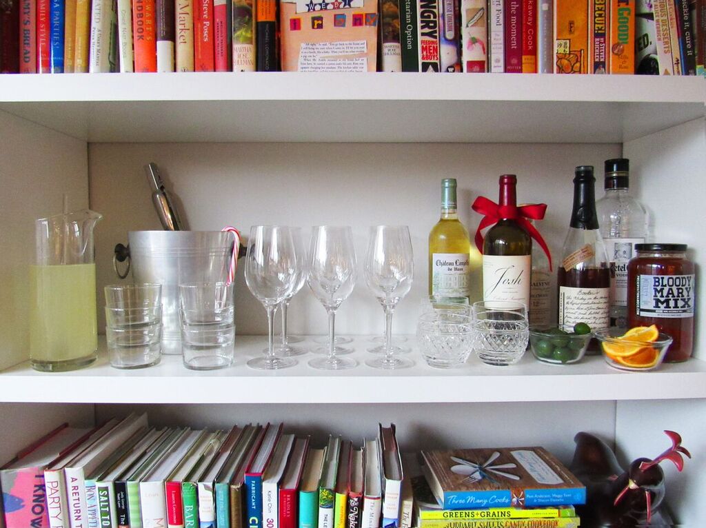 Cocktail bar set up on book shelf.