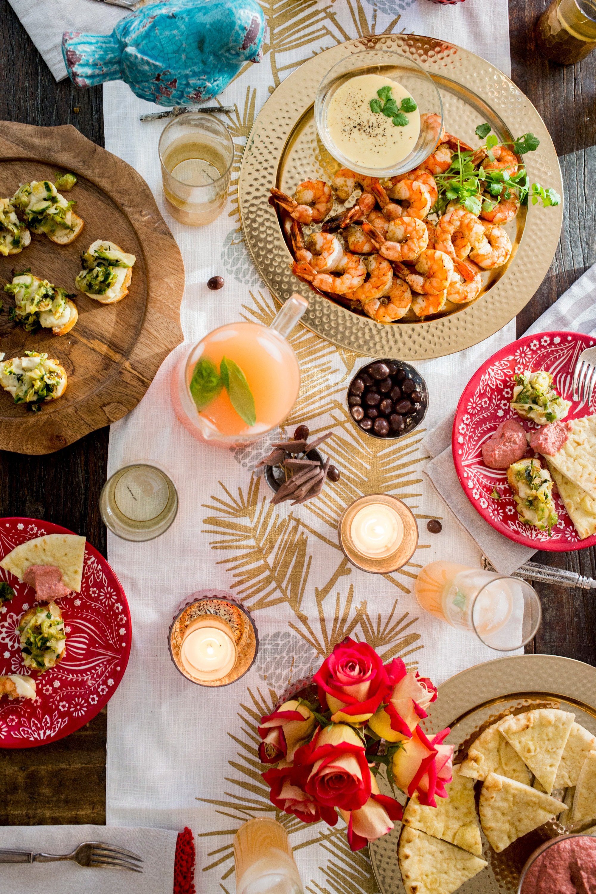 Shrimp dish, cocktails, and other foods and drinks on a holiday table.