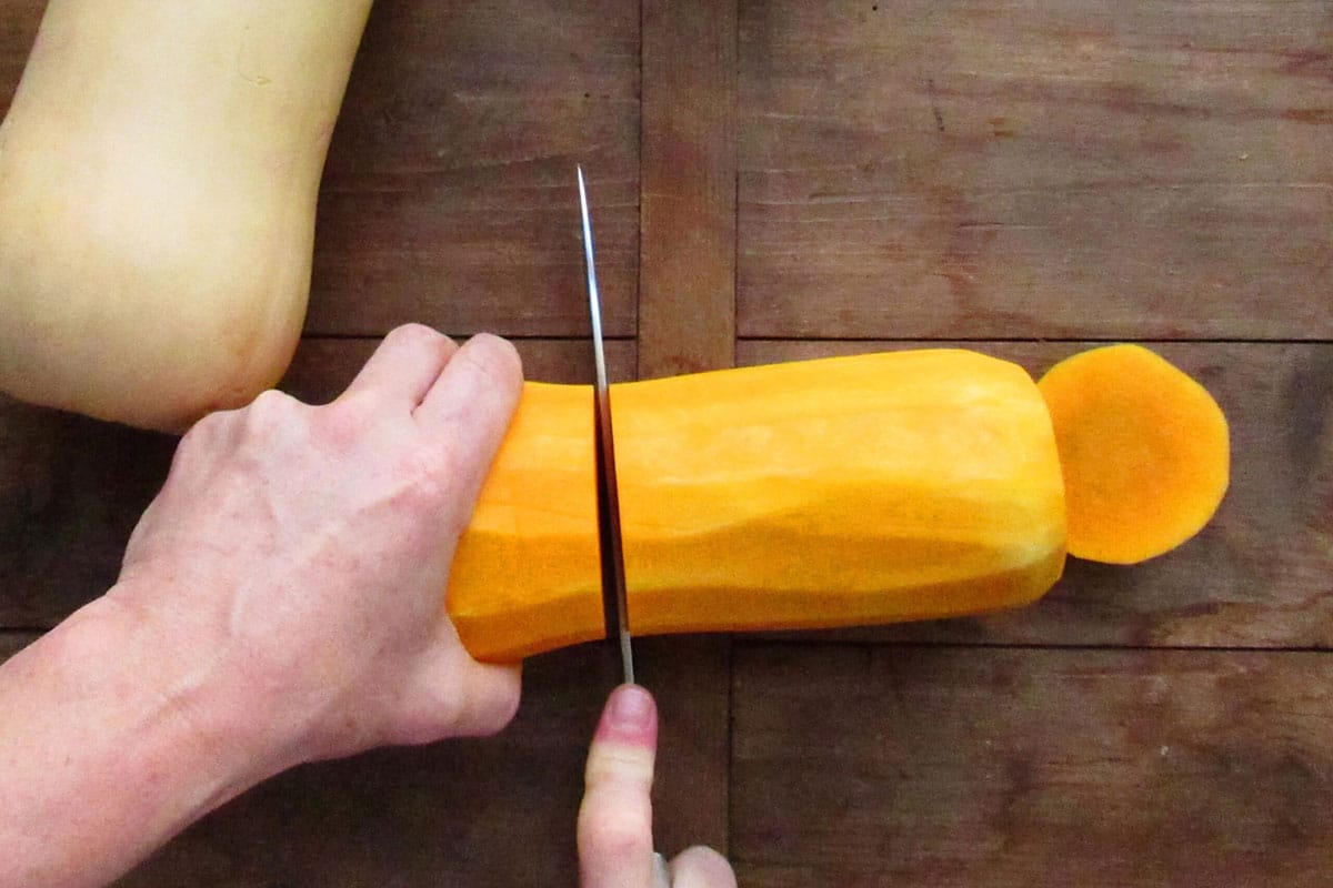Slicing butternut squash in half.