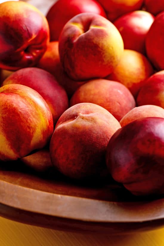 Wooden bowl of Peaches and Nectarines.