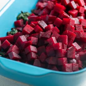 Beets and Sauteed Beet Greens in a blue baking dish.
