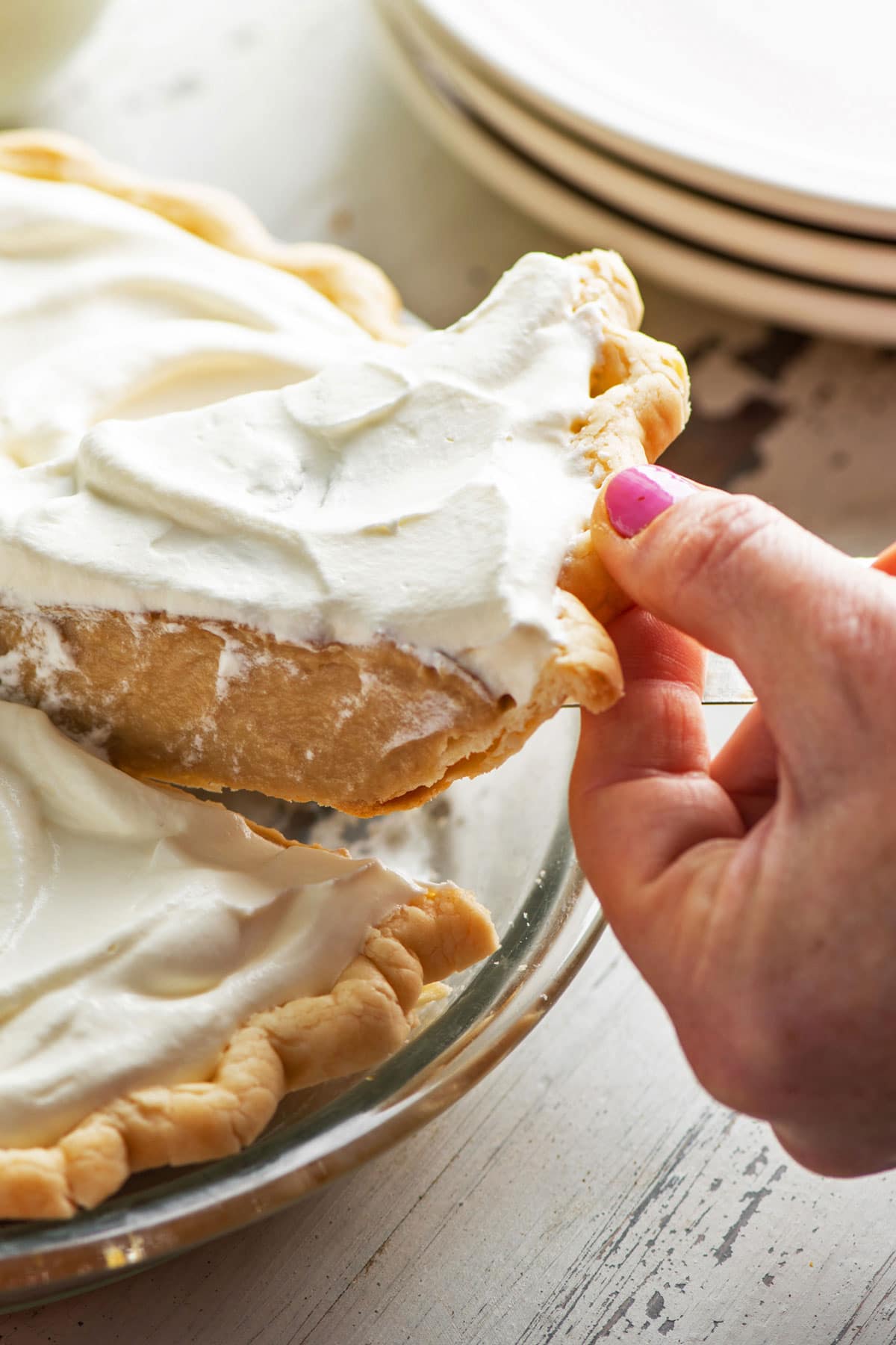 Woman taking a slice of Salted Butterscotch Pie.